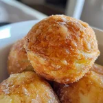 Close-up side view of homemade energy balls on a white plate.
