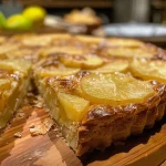 Close-up side view of a moist potato cake with a golden-brown crust.