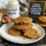 Close-up view of a moist, spiced pumpkin cookie with a golden-brown exterior.