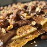 Close-up view of homemade Ferrero Rocher chocolate candies with hazelnuts.