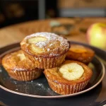 Close-up of freshly baked apple cinnamon muffins, showcasing a soft texture.