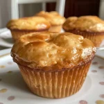 ['Deliciously baked peanut butter chocolate chip muffins in a close-up view.', 'Side view of moist muffins filled with chocolate chips and peanut butter.', 'A close-up of golden-brown muffins with melting chocolate chips on top.', 'Freshly baked peanut butter muffins with chocolate chips, showing their soft texture.']