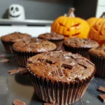 Close-up view of Halloween-themed muffins with spooky decorations.