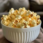 Close-up view of protein popcorn in a bowl, showcasing its fluffy texture and golden color.