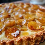 ['Close-up of a slice of creamy chestnut tart with a smooth vanilla cream topping.', 'Side view of a delicious chestnut tart, showcasing its rich filling and golden crust.', 'Detailed view of a tart filled with chestnut cream, garnished with a hint of vanilla.', 'Slice of chestnut tart displaying a velvety cream layer on a buttery crust.']