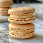 Close-up view of colorful French macarons stacked elegantly.