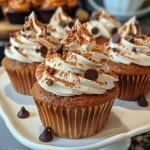 Close-up of a gluten-free Halloween cupcake decorated with chocolate eyes and a mouth.