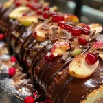 Close-up of a chocolate pear Yule log with rich frosting.
