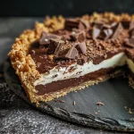 Close-up view of a rich chocolate tart with a glossy finish.