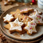 Close-up side view of spiced Christmas biscuits on a plate.