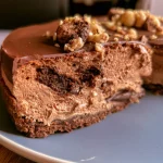 A close-up view of Tarte au Chocolat showing its rich chocolate filling and cacao crust.